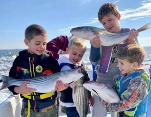 Boys holding rockfish