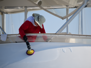 person cleaning a boat